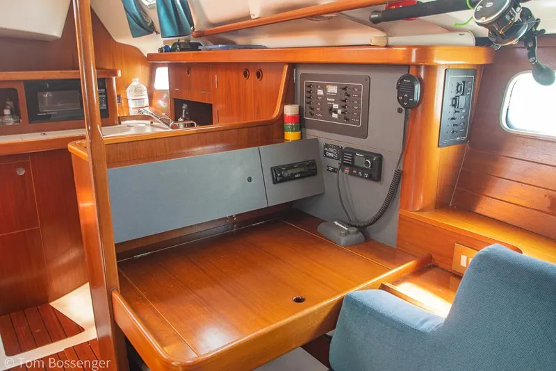 Slide: The Image of Interior of 1995 Beneteau Oceanis 35.1 sailboat with navigation station and wooden finish. - 20