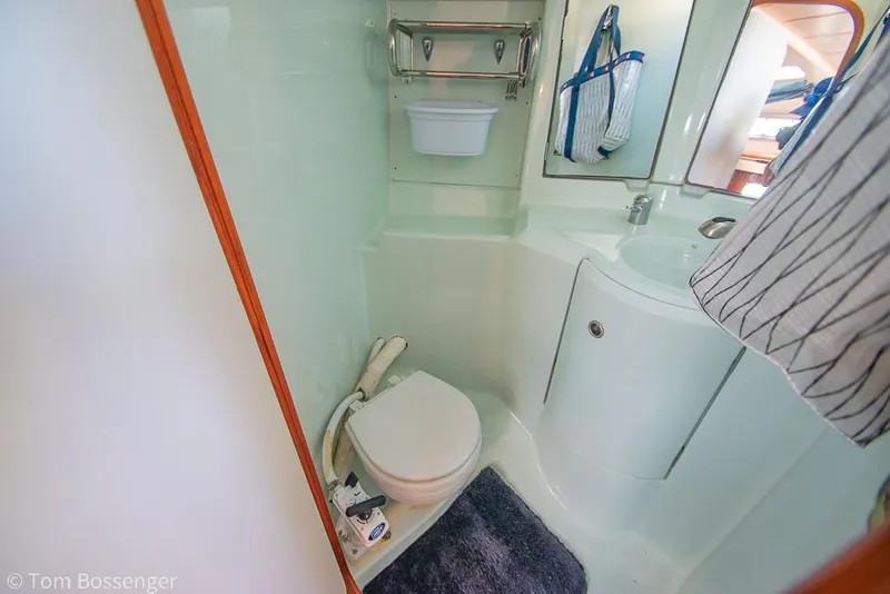 Slide: The Image of Beneteau Oceanis 35.1 1995 yacht bathroom with toilet, sink, and storage. - 24