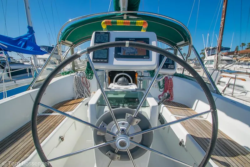 Slide: The Image of Cockpit view of a 1995 Beneteau Oceanis 35.1 sailboat with steering wheel and navigation equipment. - 27