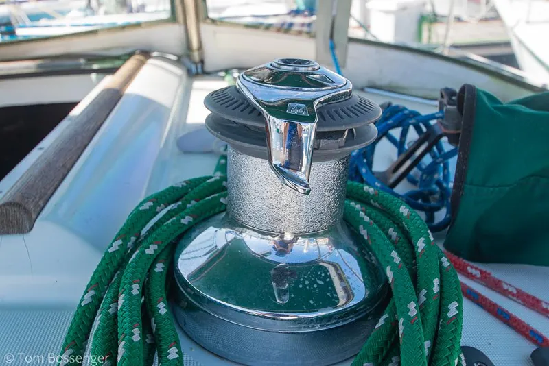Slide: The Image of Winch on 1995 Beneteau Oceanis 35.1 sailboat with green rope coiled around. - 34