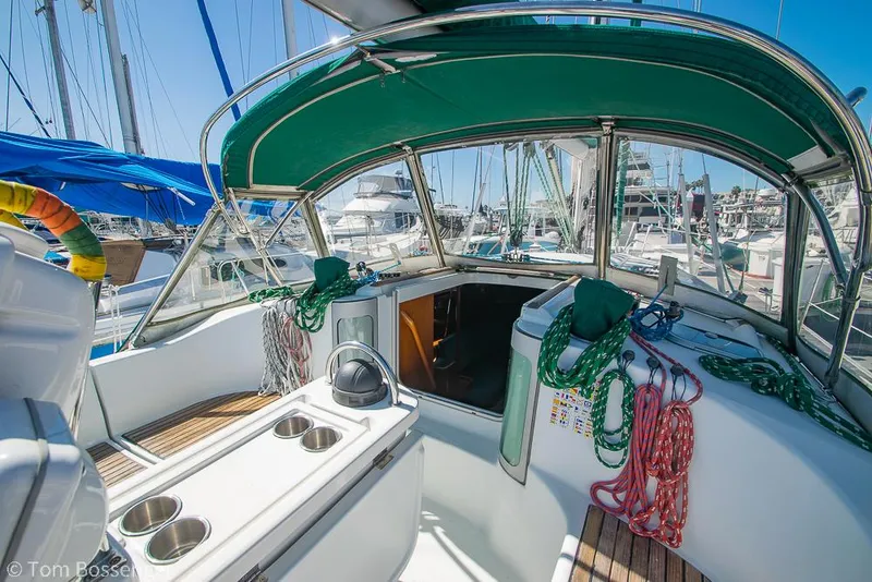 Slide: The Image of Cockpit of 1995 Beneteau Oceanis 35.1 sailboat with green canopy and marina view. - 5