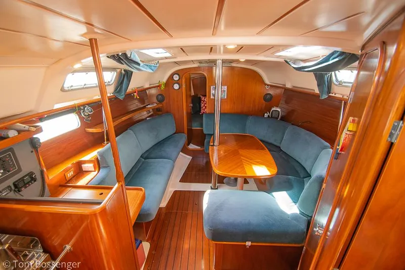 Slide: The Image of Interior of 1995 Beneteau Oceanis 35.1 sailboat with wooden finishes and blue seating. - 6