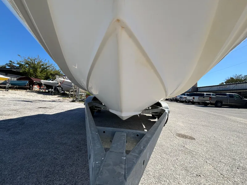 Slide: The Image of 1999 Boston Whaler 20 Ventura Bowrider on trailer, viewed from below, outdoors. - 10