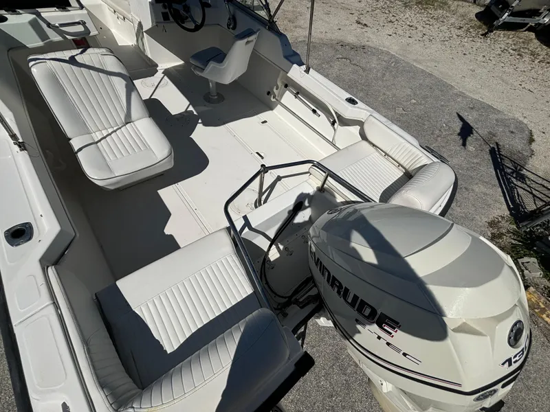 Slide: The Image of 1999 Boston Whaler 20 Ventura Bowrider with Evinrude outboard engine, spacious seating layout. - 16