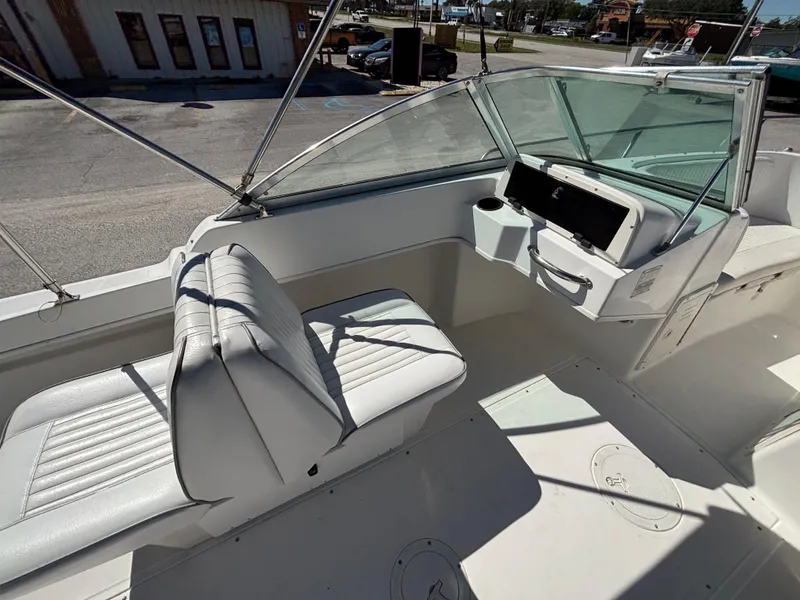 Slide: The Image of 1999 Boston Whaler 20 Ventura Bowrider interior with white seating and dashboard. - 20
