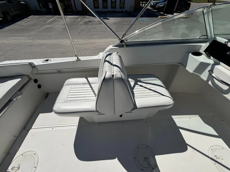 Slide: The Image of 1999 Boston Whaler 20 Ventura Bowrider interior with white seating and windshield. - 21
