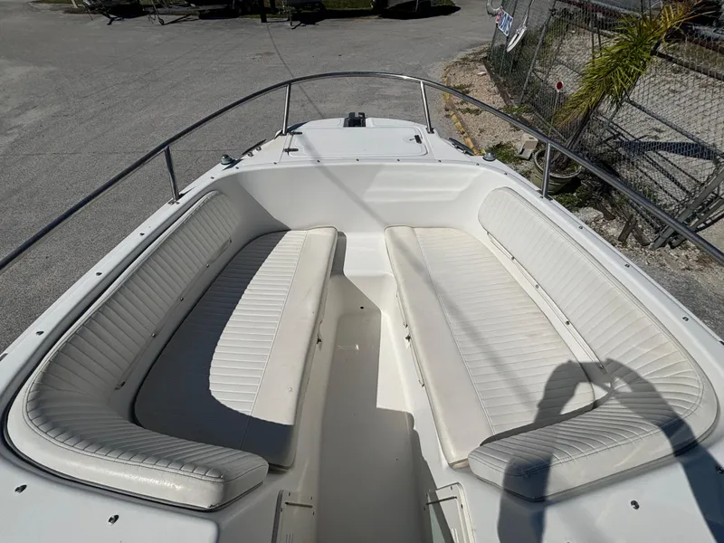 Slide: The Image of 1999 Boston Whaler 20 Ventura Bowrider with white seating and open bow design. - 23