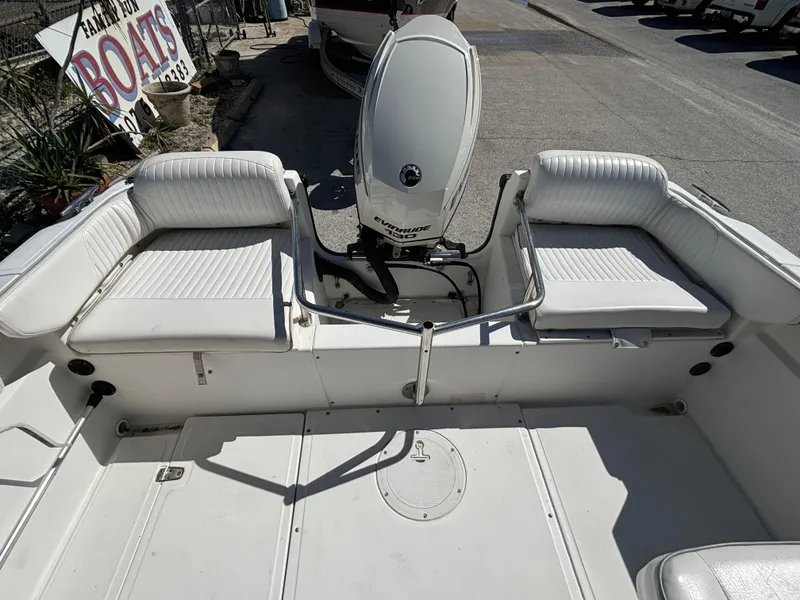 Slide: The Image of 1999 Boston Whaler 20 Ventura Bowrider with white seating and outboard motor. - 30