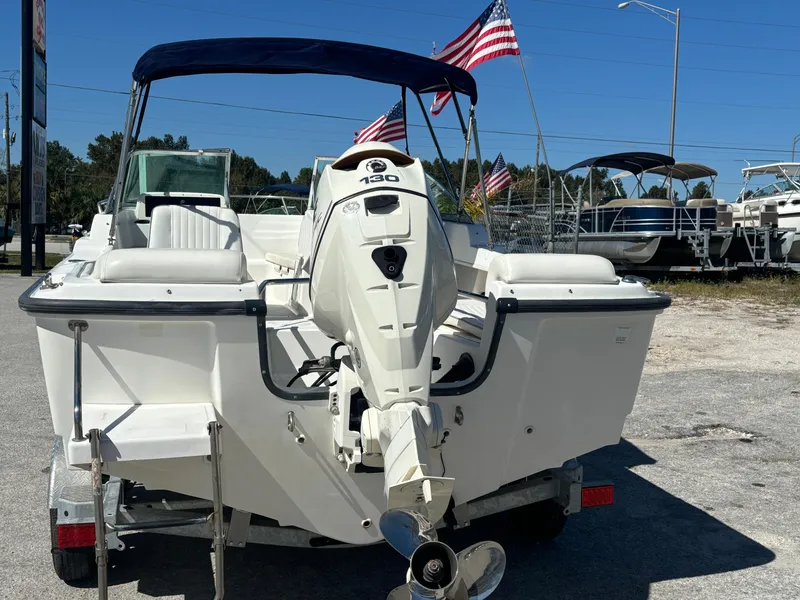 Slide: The Image of 1999 Boston Whaler 20 Ventura Bowrider with outboard motor, parked on a trailer. - 6