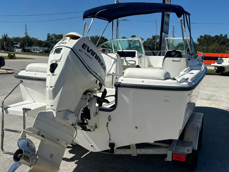 Slide: The Image of 1999 Boston Whaler 20 Ventura Bowrider with Evinrude outboard motor on trailer. - 7