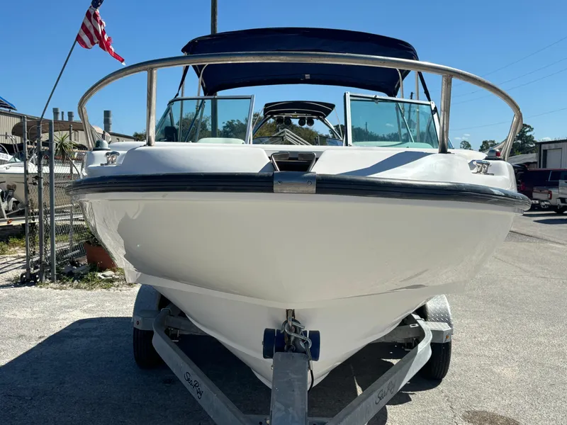 Slide: The Image of 1999 Boston Whaler 20 Ventura Bowrider on trailer, front view, with American flag in background. - 8