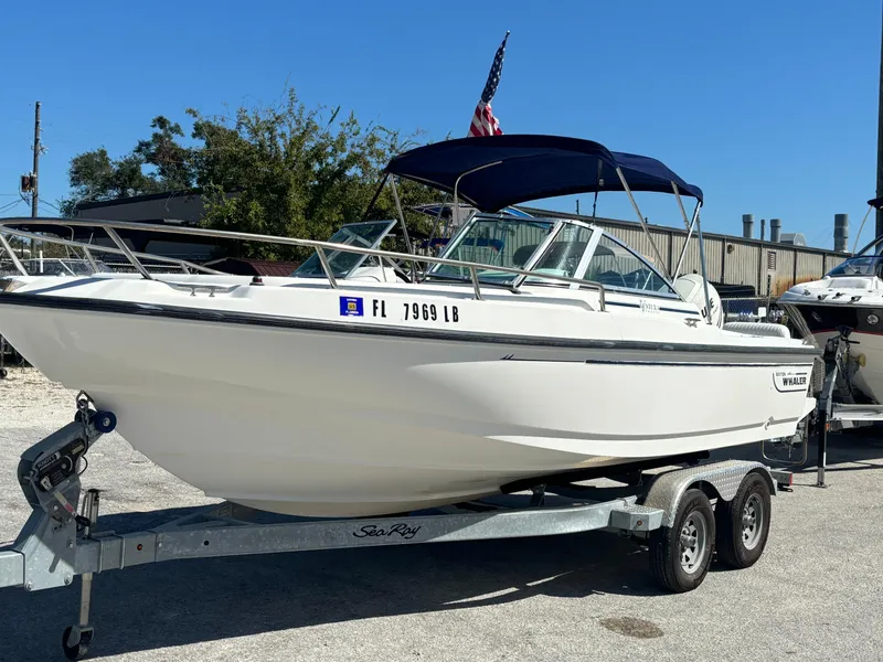 Slide: The Image of 1999 Boston Whaler 20 Ventura Bowrider on trailer, parked outdoors with blue canopy. - 9