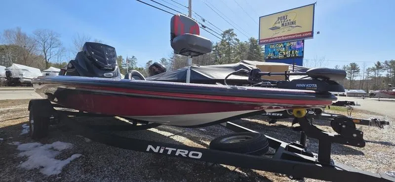 The Image of 2025 Nitro Z17 boat on trailer, parked outdoors near dealership sign. - 1