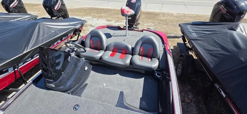 Slide: The Image of 2025 Nitro Z17 boat interior with gray and red seating, steering console, and covered engines. - 12
