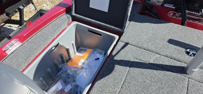 Slide: The Image of Open storage compartment in a 2025 Nitro Z17 boat, showing interior details. - 16