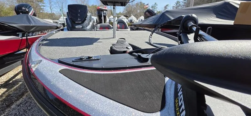Slide: The Image of 2025 Nitro Z17 boat deck with fishing equipment, parked outdoors. - 22