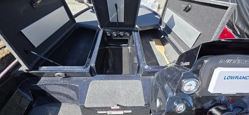 Slide: The Image of 2025 Nitro Z17 boat interior with open storage compartments and Lowrance electronics. - 6