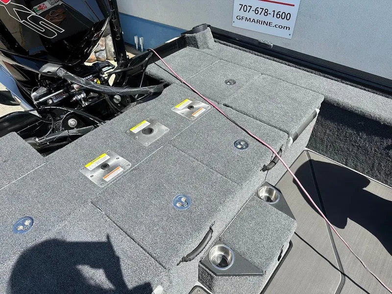 Slide: The Image of 2025 Lund 2075 Pro-V Bass XS boat deck with motor and storage compartments. - 11