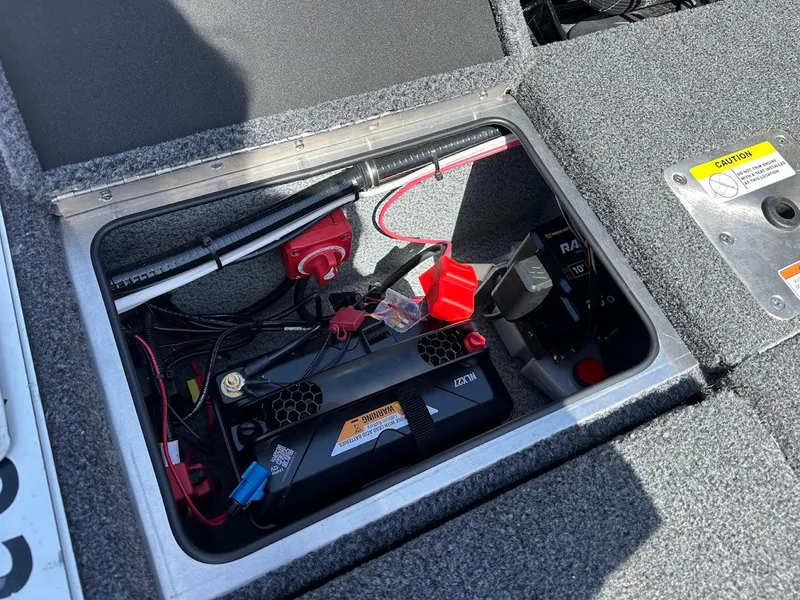 Slide: The Image of Battery compartment of 2025 Lund 2075 Pro-V Bass XS boat, showing wiring and components. - 14
