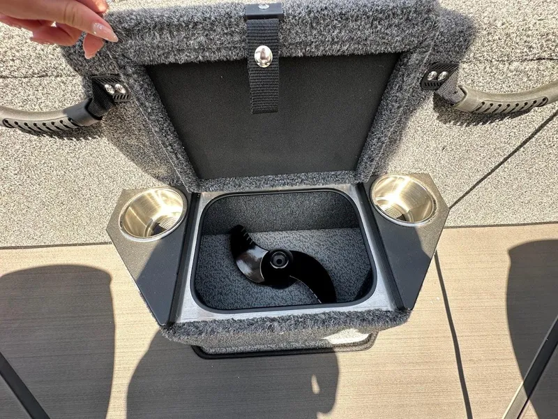 Slide: The Image of 2025 Lund 2075 Pro-V Bass XS boat storage compartment with cup holders and propeller. - 16