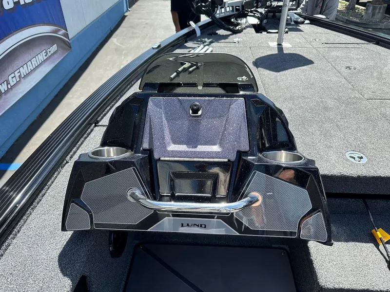 Slide: The Image of 2025 Lund 2075 Pro-V Bass XS boat console with cup holders and sleek design. - 19