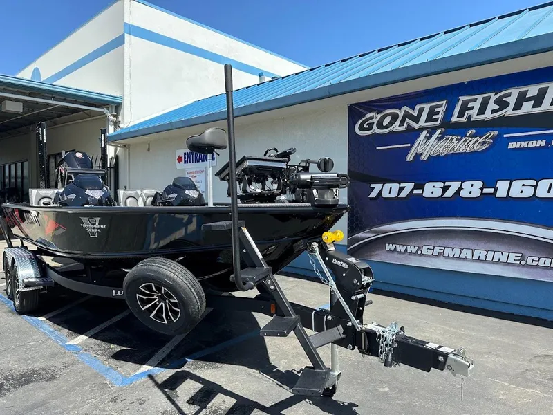 Slide: The Image of 2025 Lund 2075 Pro-V Bass XS boat on trailer outside marine store. - 2
