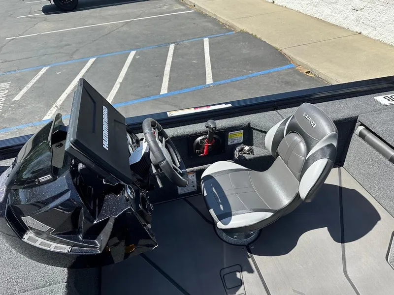 Slide: The Image of 2025 Lund 2075 Pro-V Bass XS boat interior with steering wheel and seat. - 21