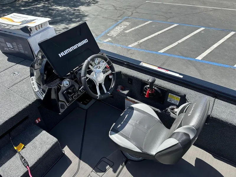 Slide: The Image of 2025 Lund 2075 Pro-V Bass XS boat interior with Humminbird electronics and steering wheel. - 22