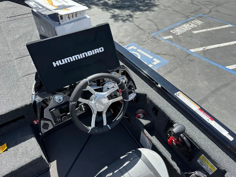Slide: The Image of 2025 Lund 2075 Pro-V Bass XS boat cockpit with Humminbird electronics and steering wheel. - 23