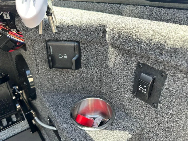 Slide: The Image of Interior of 2025 Lund 2075 Pro-V Bass XS boat with cup holder and control panel. - 25