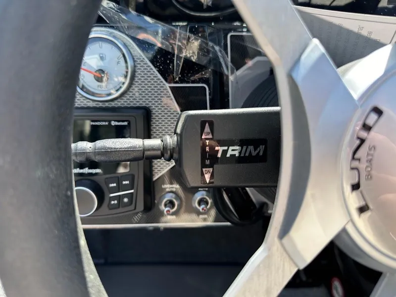 Slide: The Image of 2025 Lund 2075 Pro-V Bass XS dashboard with trim control and steering wheel. - 28