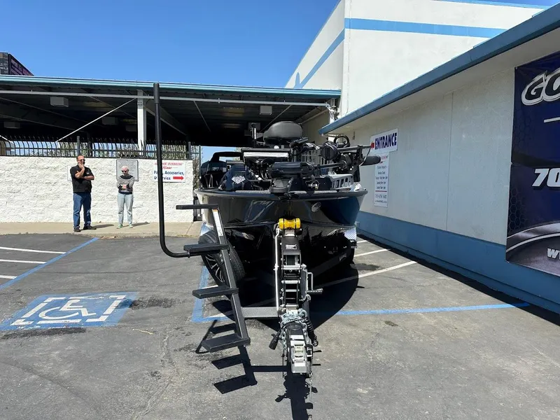 Slide: The Image of 2025 Lund 2075 Pro-V Bass XS boat parked in a lot, front view. - 3