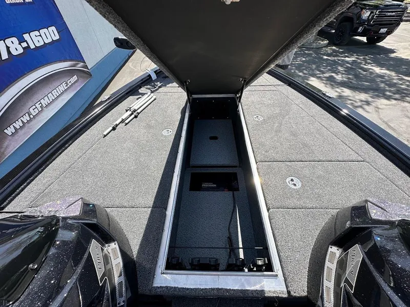 Slide: The Image of 2025 Lund 2075 Pro-V Bass XS boat with open storage compartment, showcasing spacious deck design. - 31