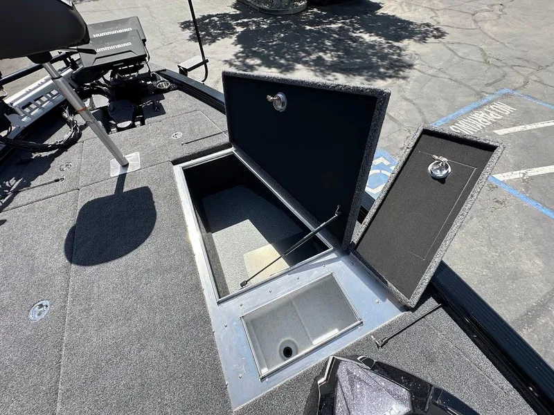 Slide: The Image of 2025 Lund 2075 Pro-V Bass XS boat with open storage compartments on deck. - 33