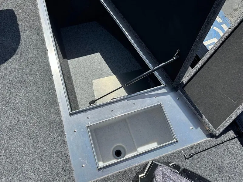 Slide: The Image of 2025 Lund 2075 Pro-V Bass XS boat storage compartment with open hatch. - 34