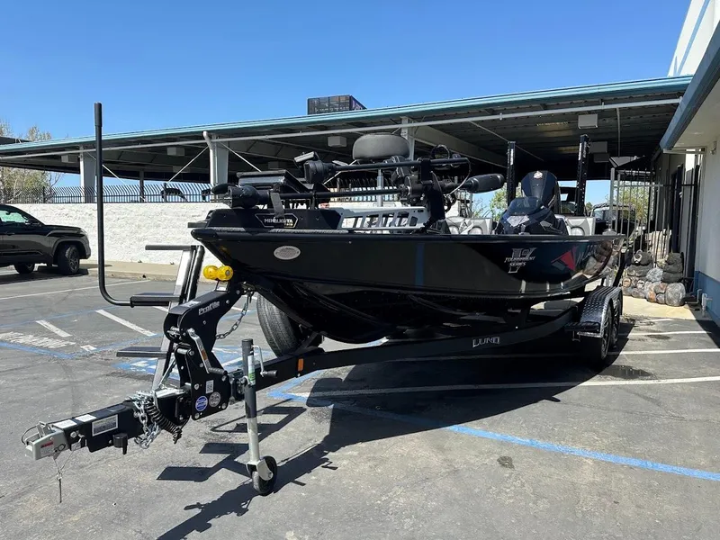 Slide: The Image of 2025 Lund 2075 Pro-V Bass XS boat on trailer in parking lot. - 4