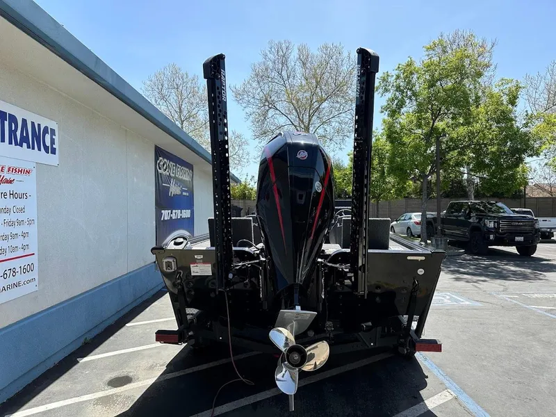 Slide: The Image of 2025 Lund 2075 Pro-V Bass XS boat parked outside a building. - 8