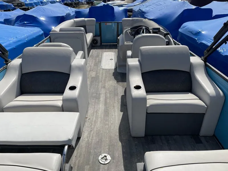 Slide: The Image of 2019 Crest Classic Platinum 220 SLRC pontoon boat interior with gray seating and wood-style flooring. - 11