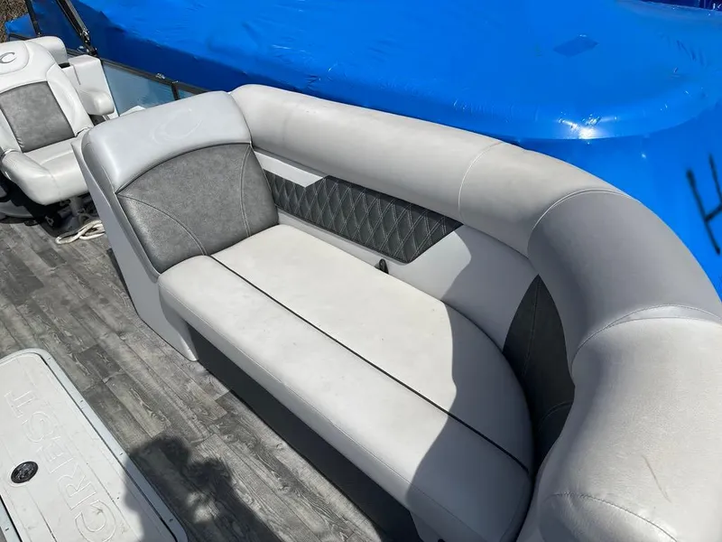 Slide: The Image of 2019 Crest Classic Platinum 220 SLRC boat interior with gray seating and blue cover. - 5