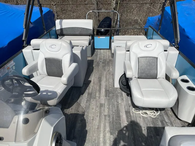 Slide: The Image of 2019 Crest Classic Platinum 220 SLRC pontoon boat interior with plush seating and modern design. - 6