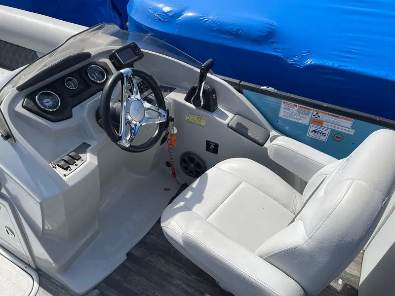 Slide: The Image of 2019 Crest Classic Platinum 220 SLRC boat cockpit with steering wheel and controls. - 8