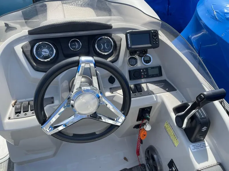 Slide: The Image of Steering console of 2019 Crest Classic Platinum 220 SLRC boat with gauges and controls. - 9