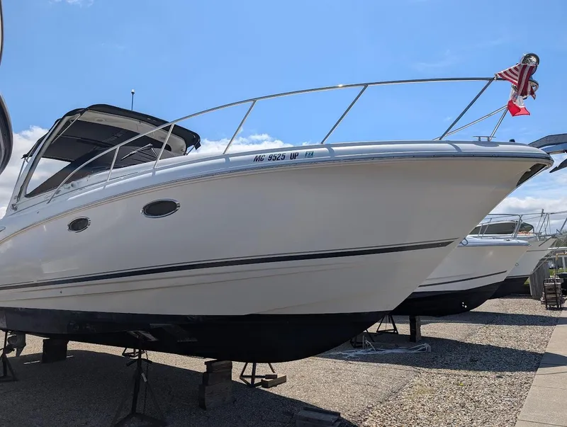 Slide: The Image of 2006 Chaparral 310 Signature boat on display, featuring sleek design and American flag. - 12