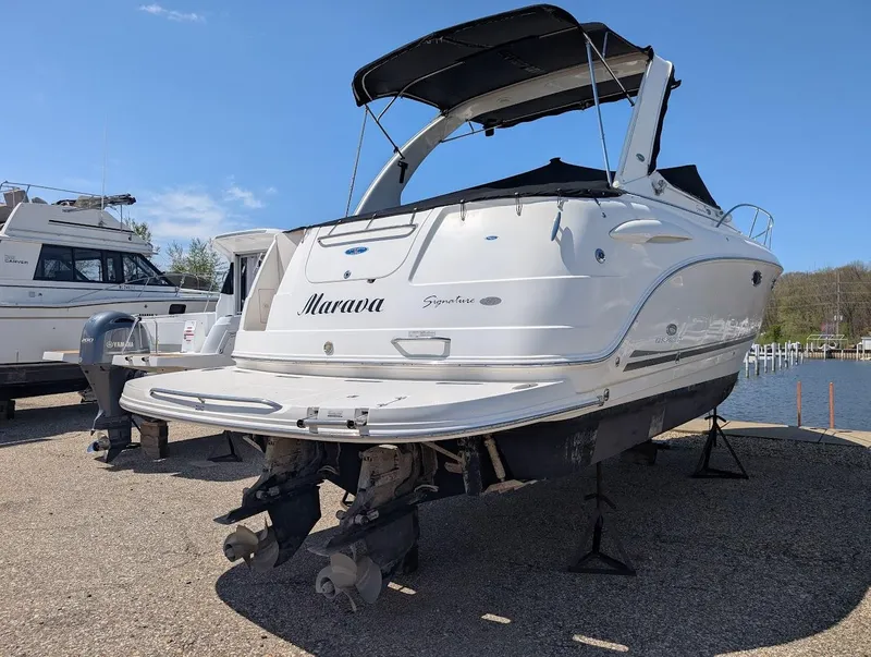 Slide: The Image of 2006 Chaparral 310 Signature boat on stands, rear view, with black canopy. - 13