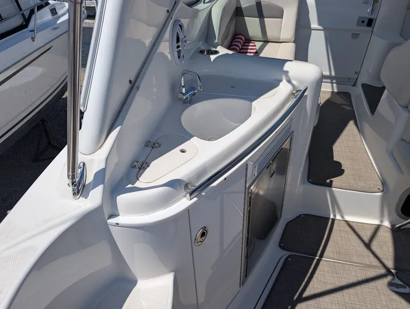 Slide: The Image of 2006 Chaparral 310 Signature boat interior with sink and seating area. - 16