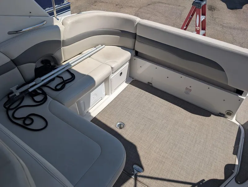 Slide: The Image of 2006 Chaparral 310 Signature boat interior with beige seating and storage compartments. - 17