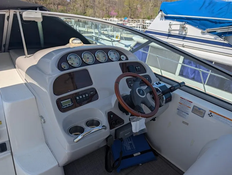 Slide: The Image of 2006 Chaparral 310 Signature boat dashboard with gauges and steering wheel. - 18