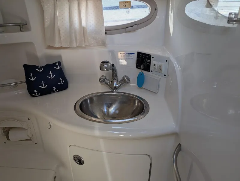 Slide: The Image of 2006 Chaparral 310 Signature boat interior with sink and nautical decor. - 26