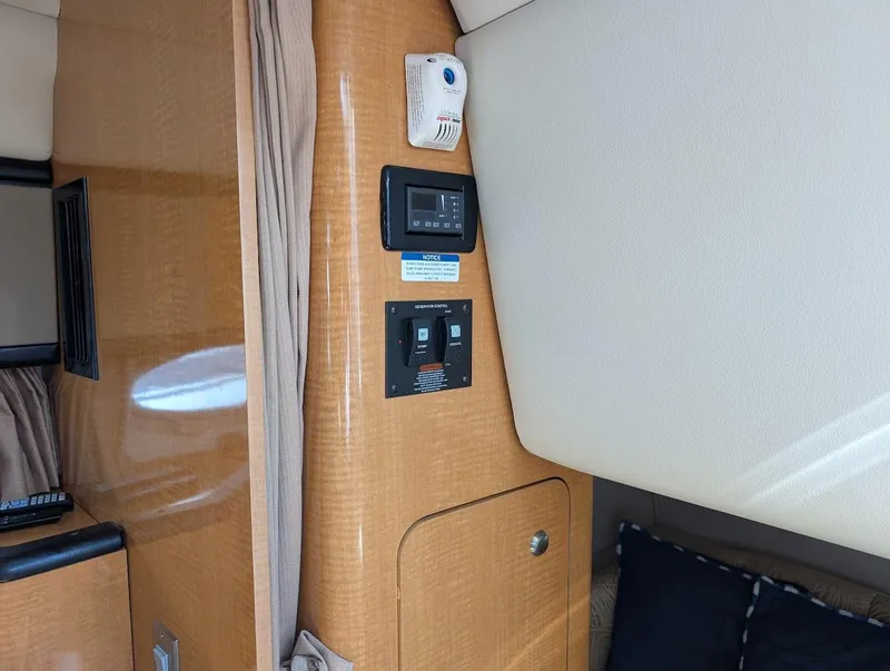 Slide: The Image of Interior of 2006 Chaparral 310 Signature boat with control panel and wood finish. - 28