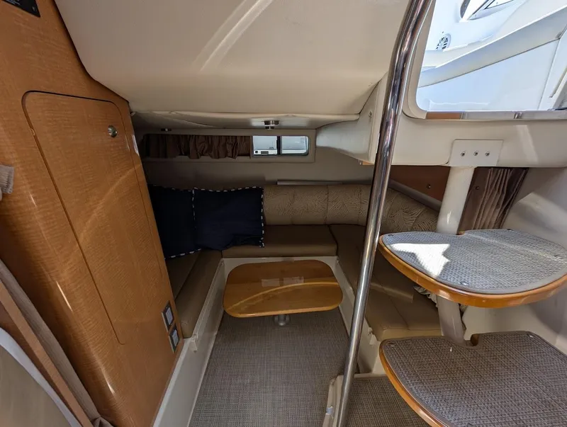 Slide: The Image of 2006 Chaparral 310 Signature cabin interior with seating, table, and stairs. - 29